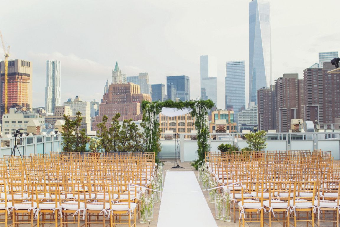 ourdoor new york wedding ceremony with new york city skyline in the background
